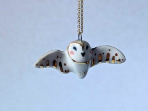 cute handmade porcelain barn owl pendant with wings out and gold