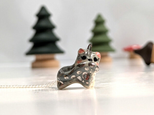 adorable snow leopard pendant tail in mouth