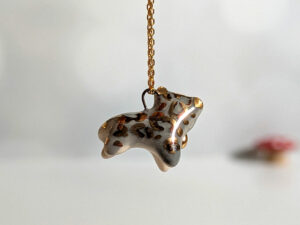 tail in mouth snow leopard pendant with gold