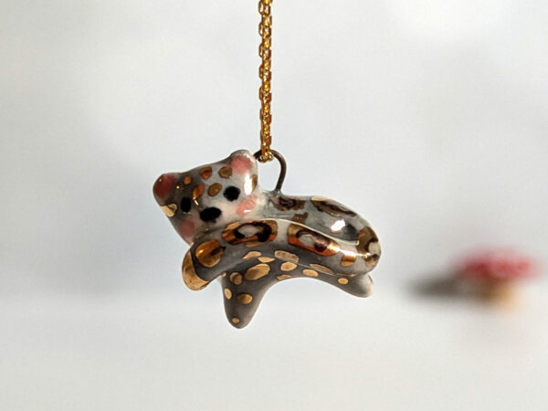 tail in mouth snow leopard pendant with gold