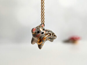 tail in mouth snow leopard pendant with gold