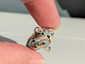 tail in mouth snow leopard pendant with gold