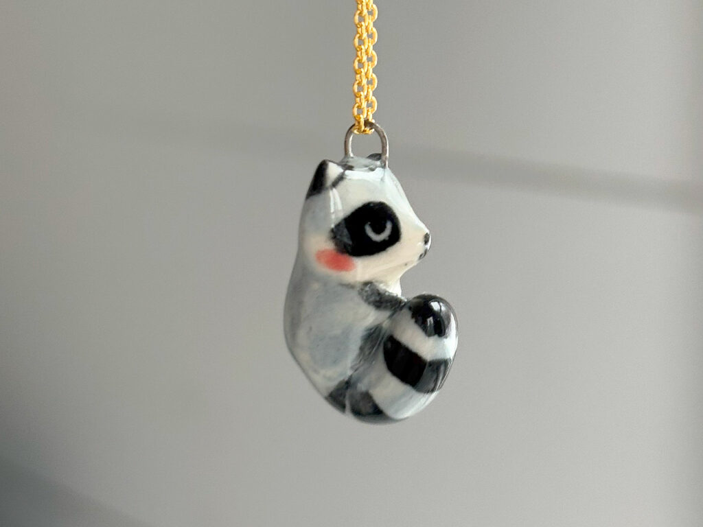 cute raccoon pendant sleepy