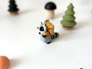 adorable raccoon figurine with a cute backpack porcelain