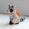 adorable raccoon figurine with a cute backpack porcelain