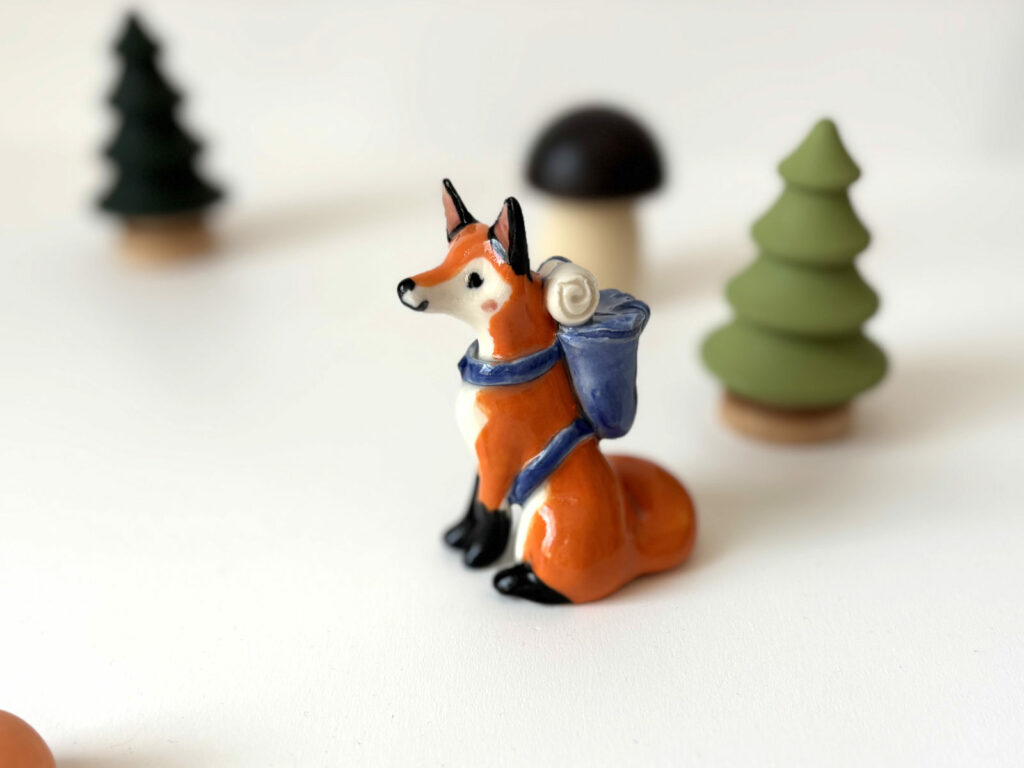 adorable fox figurine with a backpack, handmade porcelain sculpture