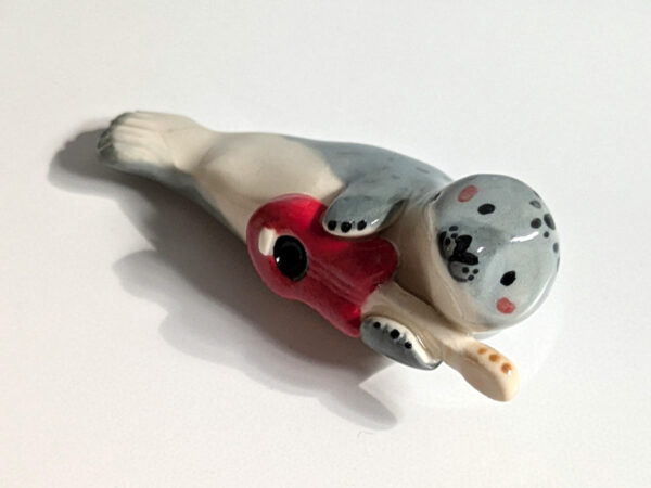 adorable seal playing guitar figurine