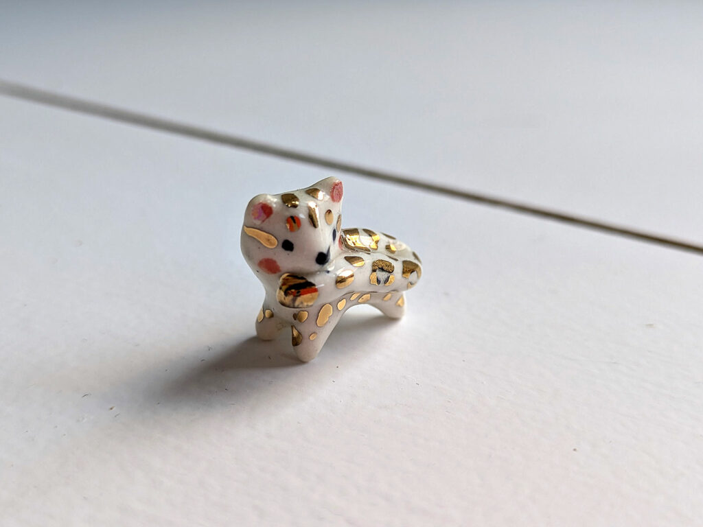 tail in mouth snow leopard pendant with gold