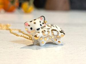 tail in mouth snow leopard pendant with gold