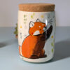 lidded vessel for loose leaf tea or ground coffee, illustrated with a red panda