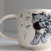 snow leopard tail in mouth mug