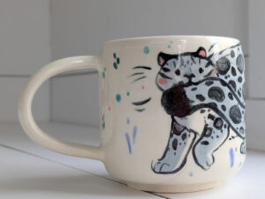 snow leopard tail in mouth mug