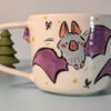 cute little bat mug with a tiny bat sculpted under the handle