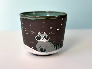 big black cup with a cute raccoon