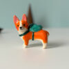 adorable corgi figurine in a backpack