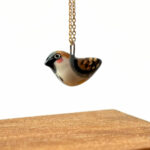 very cute handmade sparrow pendant in porcelain and gold