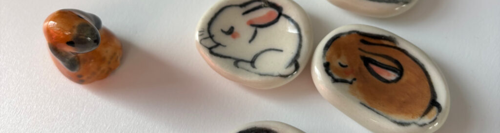 ceramic worry stone with bunnies painted 